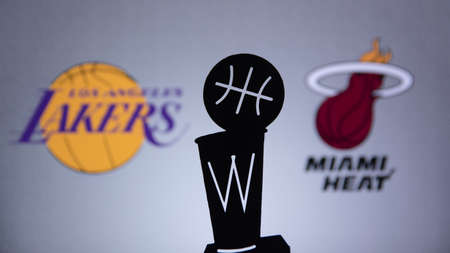 ORLANDO, USA. SEPTEMBER. 19: NBA Final 2020, Los Angeles Lakers vs Miami Heat. Covid Season final in Bubble. Silhouette of NBA Trophy. Logos of NBA Finalists on the screen in background.のeditorial素材
