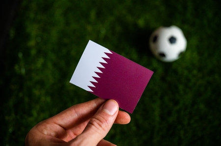 Qatar Mini Flag and football ball in backgroundの写真素材