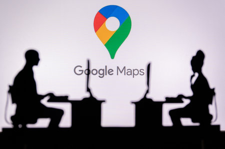 INDIA, NEW DELHI. JANUARY 30, 2023: Google Maps. A Glimpse into the Tech World: Silhouette of Software Developers with Company Logo Behind Themのeditorial素材