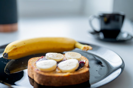 Well-balanced morning: A nutritious breakfast spread with a banana and whole-grain breadの写真素材