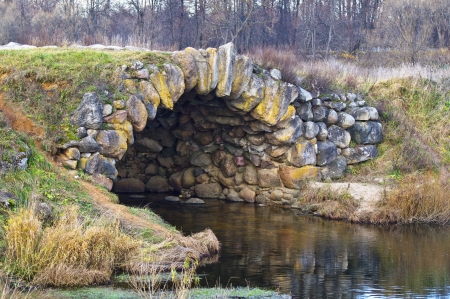 A bridge of cobblestone over a small rivulet. The village of Grusiny Torzhok district of Tver provinceの写真素材