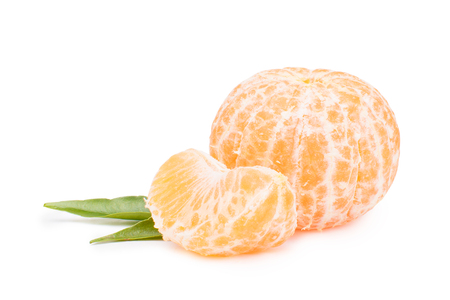 peeled whole tangerine with mandarin leaf on white background.の写真素材