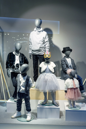 Shop window with plastic mannequin man and woman and children, dress mannequinsの写真素材