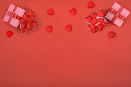 Two gift box with red heart inside and around on red background. Valentines day, mothers day, holiday, new yearの写真素材