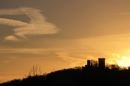 Silhouette of a ruin of a castle against the setting sunの写真素材