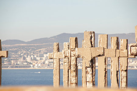 Stone crosses on the background of the sea and the city.の写真素材