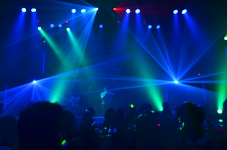 silhouette concert in front of stage.Defocused entertainment concert lighting on stage, blurred disco party.の写真素材