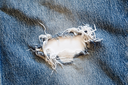 torn old blue jeans backgroundの写真素材
