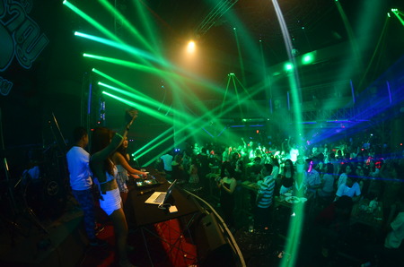 silhouette concert in front of stage.Defocused entertainment concert lighting on stage, blurred disco party.の写真素材