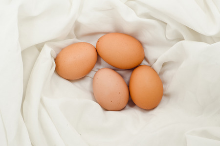 Eggs on fabric White.Chicken eggs on white fabric.easter eggs on fabric with copy space.の写真素材