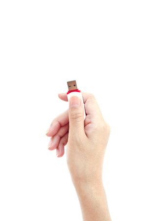 Flash drive in hand isolated on white background.の写真素材