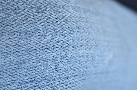 Jeans background texture,Blank real leather jeans label sewed on old worn jeans.