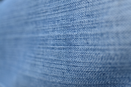 Jeans background texture,Blank real leather jeans label sewed on old worn jeans.