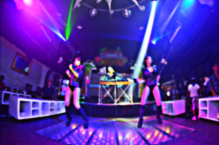 blur silhouettes of concert crowd in front of bright stage lightsの写真素材