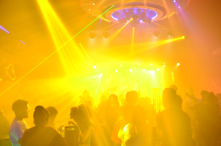 club party is blurred for background.Light in club party Show And Silhouette hands enjoying the club...