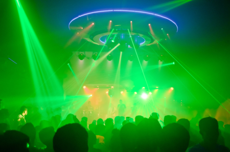 club party is blurred for background.Light in club party Show And Silhouette hands enjoying the club party with concert. Blurry night club DJ party people enjoy of music dancing sound .の写真素材