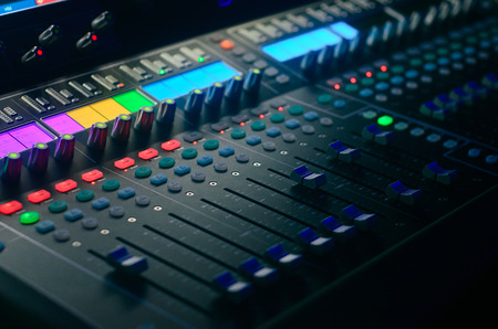 Board mixing console. Mixer. The sound engineer's console. Sound engineer's fingers are pressing the...