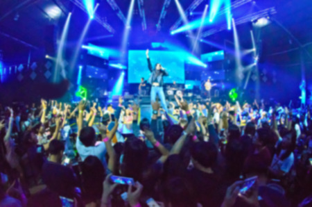 Club Party Blurred For Background,night party festival crowd of people silhouettes hands up with confettiの写真素材