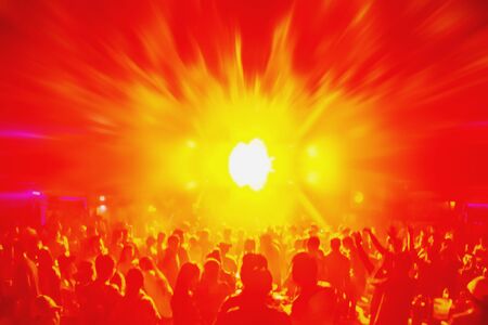 Lighting in club party,blur silhouettes of happy people crowd having fun and dancing in club party.