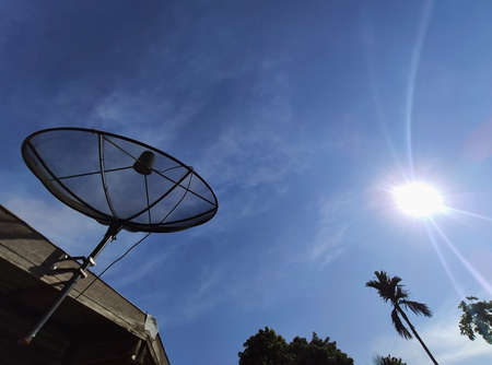 Satellite dishes communication technology network with sun and Blue sky surf in background,Satellite dish In the countrysideの写真素材