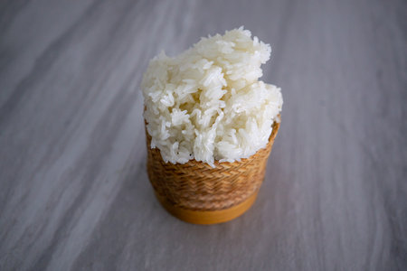 Hand taking some sticky rice at the hungry time. This food style is the culture of the people in northeast of Thailandの写真素材