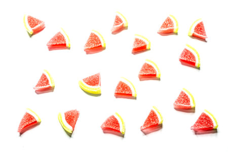 Jelly candies. Top view of watermelon jelly candies sprinkled with sugar on a blue background. Watermelon marmalade. Selective soft focus.Bright summer background.の写真素材