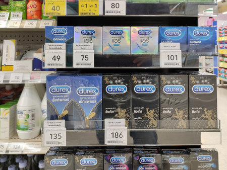 Khon Kaen, Thailand - JULY 26, 2022: Condoms shelf on the counter of supermarket.Row of variety condom. Condoms in supermarket. Condoms Durex, akamoto on the counter. Aids preventionの写真素材