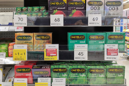 Khon Kaen, Thailand - JULY 26, 2022: Condoms shelf on the counter of supermarket.Row of variety condom. Condoms in supermarket. Condoms onetouch. Aids preventionの写真素材
