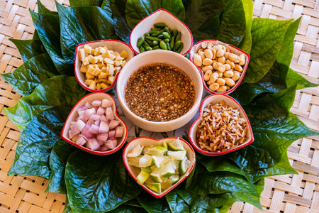 "Miang Kham" is a tasty snack often sold as Thailand street food.It involves wrapping little tidbits of several items in a leaf, along with a sweet-and-salty sauce.Savoury Leaf Wrapsの写真素材