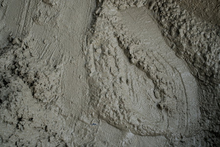 High-Resolution Texture of Freshly Poured Wet Concrete Surface Close-Up: Ideal for Backgrounds, Construction, and Architectural Design Conceptsの写真素材