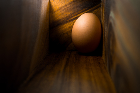 Egg in wood box,Alone of the egg with lighting in the morningの写真素材