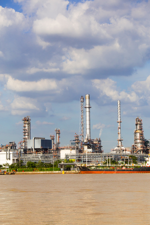 Factory of gas plant in the river and smoke emitted from the factoryの写真素材
