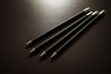 Black color pencil in dark light backgroundの写真素材
