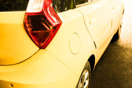 Cap oil of yellow car with taillight in car parkの写真素材