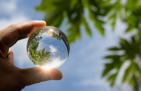 A hand holding crystal ball for eco friendly or sustainable resources concept. Saving environment...