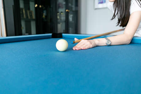 Asian woman playing snooker in the club
