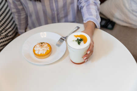Young women holding drinks in a restaurantの写真素材
