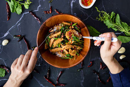 Top view of people eating Basil Menu Thai food on table together.