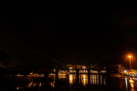 KANCHANABURI, THAILAND - DECEMBER 23, 2021: Tourists on the bridge over the river Kwai (Khwae) in Kanchanaburi, Thailand. This bridge is famous for its history in WW2.のeditorial素材