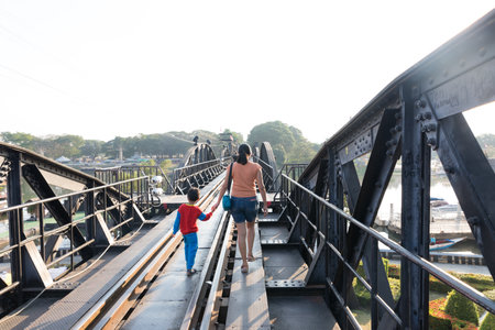 KANCHANABURI, THAILAND - DECEMBER 23, 2021: Tourists on the bridge over the river Kwai (Khwae) in Kanchanaburi, Thailand. This bridge is famous for its history in WW2.のeditorial素材