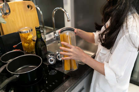 women picking up spaghetti, cooking
