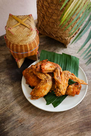 fried chicken Traditional Asian or Northeastern Thai food half grilled chicken wing.