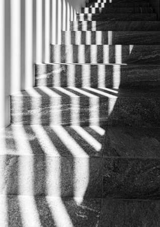 Graphic shapes - parallel shadow lines on stairs. High contrast.