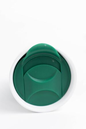 green thermo cup with a lid on a white background
