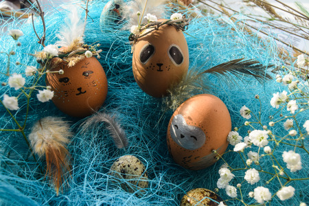 Easter holiday concept with cute handmade eggs, rabbit, chicks, owl, panda and deer. Creative eggs...