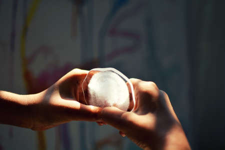 A boy holding and playing with an Ice peace.の写真素材