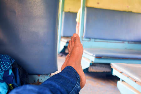 Man's feet in a train. Traveling by train concept.の写真素材