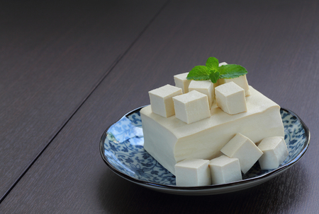 Tofu fresh is raw food with vegetarian food, wood background.の写真素材