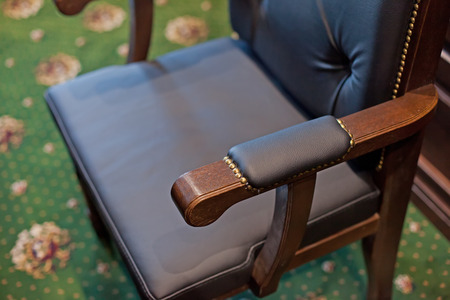 Classic wooden chair in chief cabinet in old style