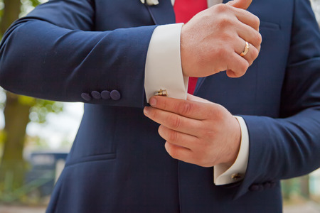 Hands of wedding groom getting ready in suit. Backgroundの写真素材